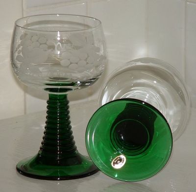 Pair of medium  Roemers
Green stems, clear bowl with engraved vine leaves and grapes and etched tendrils. Paper label on base says: Made in Germany. 114mm high, 65mm diameter.
