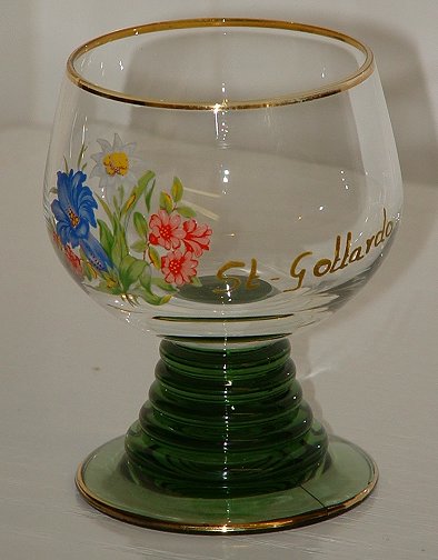 Medium  Roemer
3.5" tall, solid green stem/foot. One side of bowl has floral transfer print with the painted in gold words St-Gollardo alongside it. Unknown maker.
