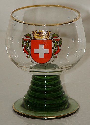 Medium  Roemer
3.5" tall, solid green stem/foot. Bowl has a depiction of the Swiss arms on one side, with the words SUISSE SCHWEIZ SVIZZERA below the arms. Unknown maker.
