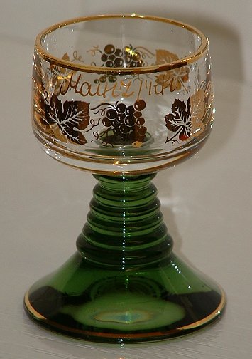 Small  Roemer
3" tall, solid green stem/foot. Gilded vine leaves and grapes, bears the words Mainz / Rh. above the vineleaf pattern.Unknown maker.
