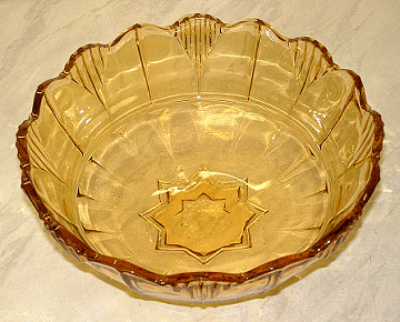 Sowerby amber dish
Patterned amber glass dish with star insert pattern on base, looks like it should have had a stand. Update: I have seen another one of these with small footed dishes in the same pattern as a fruit set, bearing labels for Sowerby Tynesyde Glassware (and the large bowl did not have a base in the set I saw).
Keywords: Sowerby pressed England