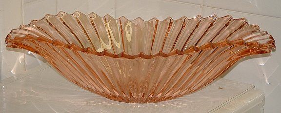 Sowerby Tyneside large flower bowl (has chrome stand and metal flower grid)
Pink glass. Glass vase is 13" wide, 7" deep and 3" tall, chrome stand is 17" wide, 7" deep, 5" tall.  Possibly Sowerby Tyneside
Keywords: Sowerby England pressed