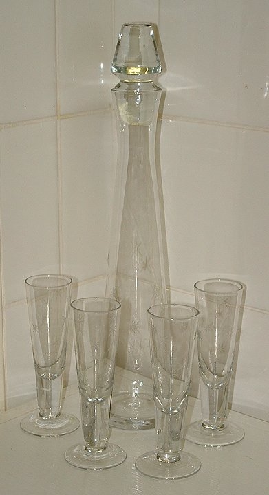 Clear glass decanter set with incised star pattern
Decanter and four glasses, unknown maker, no marks. 
