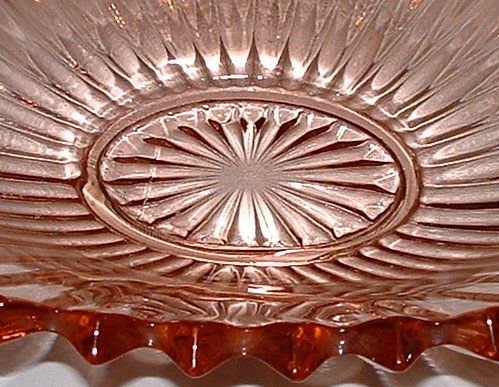 Sowerby Tyneside large flower bowl on chrome stand with metal flower grid - base detail
Pink glass. Glass vase is 13" wide, 7" deep and 3" tall, chrome stand is 17" wide, 7" deep, 5" tall. 
Keywords: Sowerby England pressed