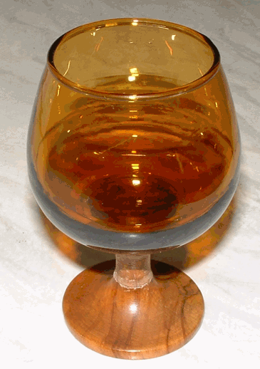 Brandy Balloon - View 1
Amber glass and wooden base brandy balloon. Unknown maker... one of a set of six with the carousel also shown above.
