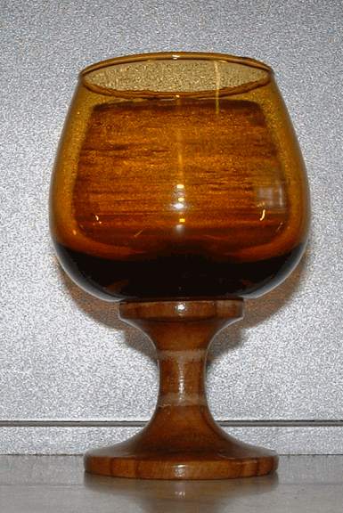 Brandy Balloon - View 2
Amber glass and wooden base brandy balloon. Unknown maker... one of a set of six with the carousel also shown above. 
