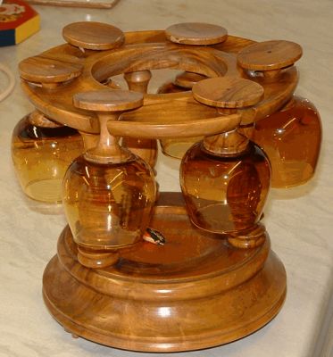Carousel with six brandy balloons
Amber glass bowls and wooden stems. The base is musical (movement by Reuge of Switzerland) plays theme from Dr Zhivago when the bottle which can be placed in the centre is lifted. 
