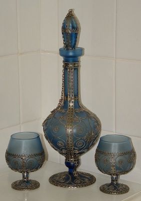 Decanter and four goblets
Blue glass encased in metal decoration. Unknown maker but matches a labelled Valentine's Hand Made Cyprus bowl I have.
