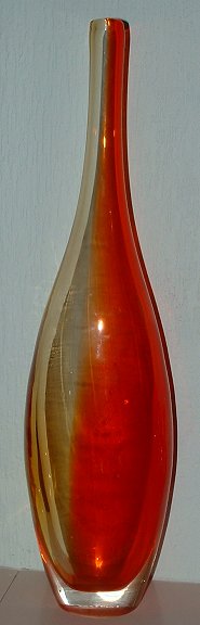 Bottle vase
Deep to very pale orange,cased clear, oval rather than round. Stands 16" 405mm) tall! No maker's marks anywhere. See also base detail and closeup of cased join at the bottom.
Keywords: cased