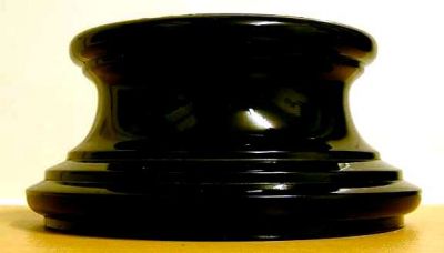 Large black plinth, probably Bagley
Base diameter: 6?" across, top diameter: 5" across, height: 3" tall.

Matches the one shown in the book, [i]Bagley Glass[/i] by Angela Bowey and Derek & Betty Parsons.
Keywords: Bagley England pressed plinth