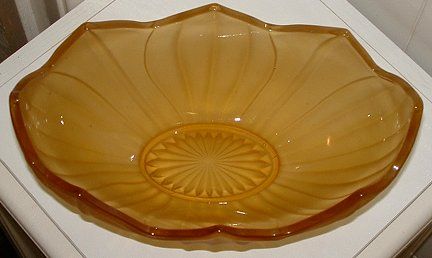 Mustard yellow satin bowl - top view
10" x 6" x 4" high. Satin finish outside, shiny inside. 
Keywords: pressed