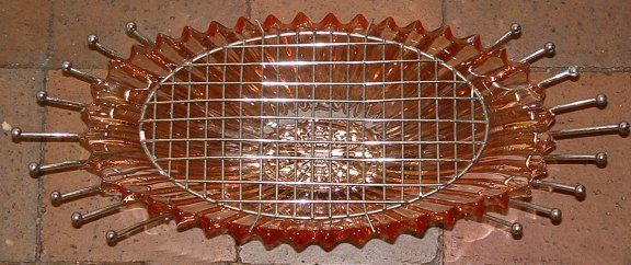 Sowerby Tyneside large flower bowl on chrome stand with metal flower grid - top view
Pink glass. Glass vase is 13" wide, 7" deep and 3" tall, chrome stand is 17" wide, 7" deep, 5" tall. Possibly Sowerby Tyneside
Keywords: Sowerby England pressed