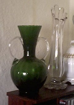 Two unknown maker vases
Green bodied vase with applied slightly spiralled clear handles.
Clear vase with wavy top edge, foot is petalled.
