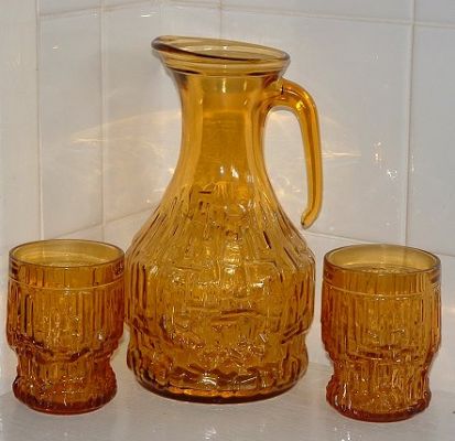 Vetreria Parmense, Italian jug and six tumblers
Looking through Ivo Haanstra's Miller's [i]Glass fact file a-z[/i] today I found the page of Bottle Marks at the back and Lo! there is the mark on my jug. The mark is actually a hexagon with a vertical dividing line, and three horizontal lines - one level, two wavy, and is for the glassmakers, [b]Vetreria Parmense[/b], part of the [b]Bormioli Rocco[/b] group, of Parma, Italy, according to Ivo's superb little tome. 
Keywords: Italy