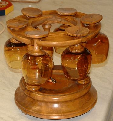 Carousel with six brandy balloons
Amber glass bowls and wooden stems. The base is musical (movement by Reuge of Switzerland) plays theme from Dr Zhivago when the bottle which can be placed in the centre is lifted. 

