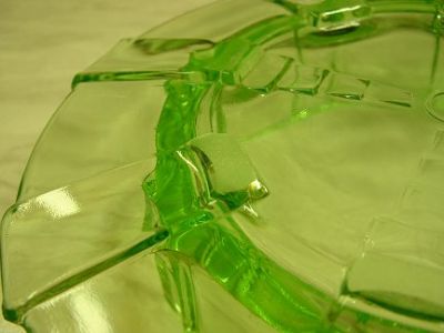 Butter dish with lid and cow handle - base detail 1
Uranium green glass butter dish and lid. Handle of lid is formed by a cow. Unknown maker. Glows brightly even in sunshine!
Keywords: uranium pressed